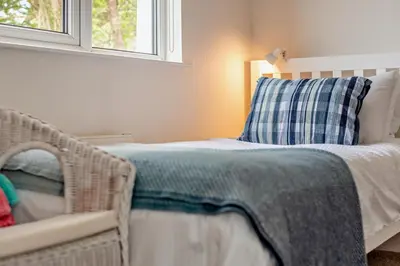 a bedroom with a bed with a pillow and a window at 3 Bed in Treknow oc-h29194 in Treknow