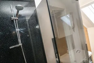 a shower with a glass door in a bathroom at Cuckoo's Rest in Penryn