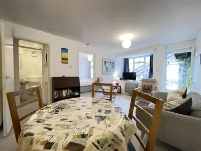 a living room with a table and a couch at 3 Redfern Court in St Ives