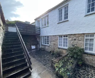 a stairway leading to a stone building with a stair case at 3 Redfern Court in St Ives
