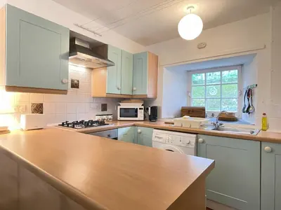 a kitchen with blue cabinets and a counter top at 3 Redfern Court in St Ives