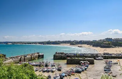 a group of boats parked in a dock on a beach at Palms 2 Private Garden Parking Central Newquay in Newquay