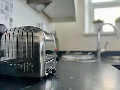 a toaster sitting on top of a kitchen counter at Luxury Sea View Apartment with Multi Room Balcony And Private Onsite Parking Only 300M From the Beach in Looe