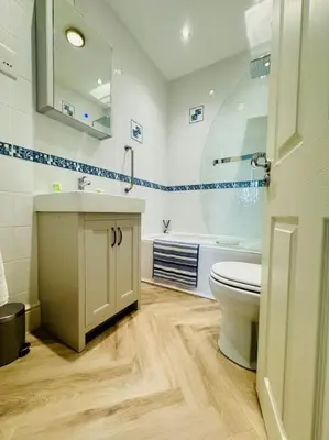 a bathroom with a toilet and a sink at Luxury Sea View Apartment with Multi Room Balcony And Private Onsite Parking Only 300M From the Beach in Looe