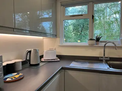 a kitchen counter with a sink and a window at Stepping Stones Cottage - Lelant, Nr St Ives in St Ives