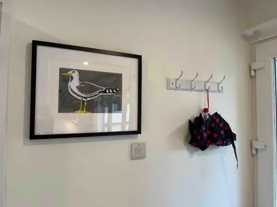 a picture of a bird hanging on a wall at Stepping Stones Cottage - Lelant, Nr St Ives in St Ives