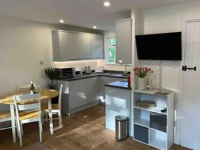 a kitchen with a table and a dining room at Stepping Stones Cottage - Lelant, Nr St Ives in St Ives