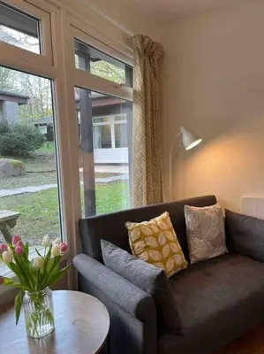 a living room with a couch and a table and a window at Stepping Stones Cottage - Lelant, Nr St Ives in St Ives