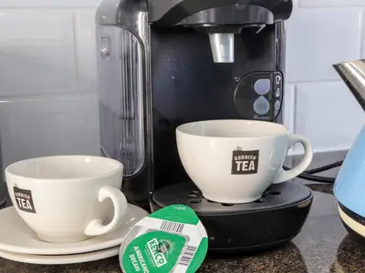 a coffee maker with two cups on a counter at Flat 1 Niles Place in Padstow