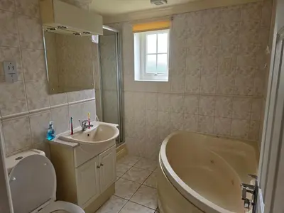 a bathroom with a tub toilet and a sink at Atlantic Reach Gold Lodge 12 in Newquay