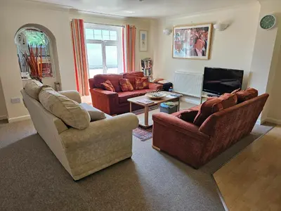a living room with two couches and a tv at Atlantic Reach Gold Lodge 12 in Newquay
