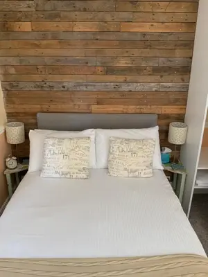 a bedroom with a white bed with two pillows at Green Apple Bed and Breakfast in St Ives