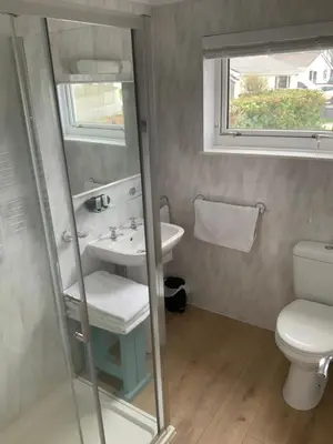 a bathroom with a sink and a toilet at Green Apple Bed and Breakfast in St Ives