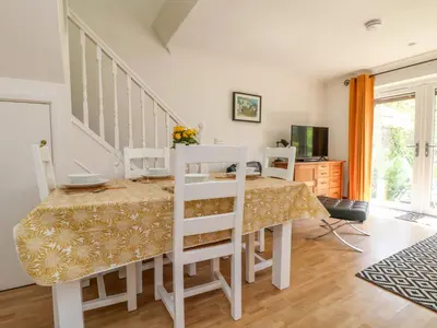 a dining room with a table and chairs at Carrick Cottage in Falmouth