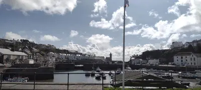 a body of water with boats in a harbor at The Samphire Cottage in Porthleven