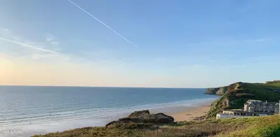 a view of a beach with a house and the ocean at 2 Boathouse Terrace in Wadebridge