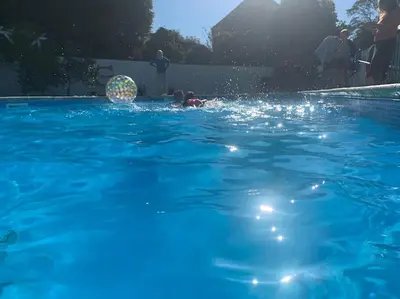 a person in a pool with a ball in the water at Siblyback Cottage in Launceston