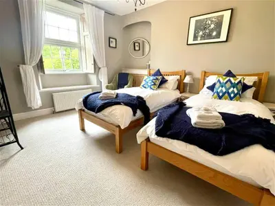 a bedroom with two beds and a window at Truck House, Luxury accommodation, pet friendly, Probus in Truro