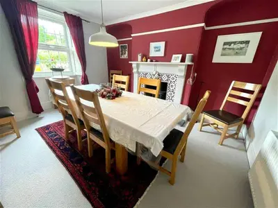 a dining room with a white table and chairs at Truck House, Luxury accommodation, pet friendly, Probus in Truro