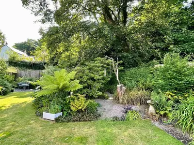 a garden with plants and trees and a path at Truck House, Luxury accommodation, pet friendly, Probus in Truro