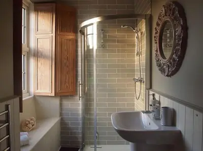 a bathroom with a shower and a sink and a mirror at Truck House, Luxury accommodation, pet friendly, Probus in Truro