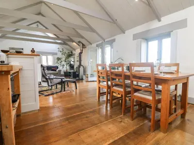 a kitchen and dining room with a table and chairs at An Skyber in Penzance