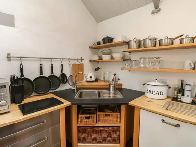 a kitchen with a sink and a counter at An Skyber in Penzance