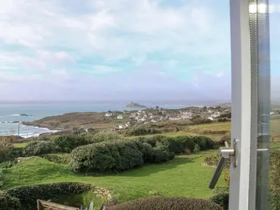 a view of the ocean from a house at An Skyber in Penzance