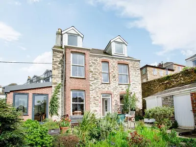 an exterior view of a brick house with windows at Chapel House in Polruan