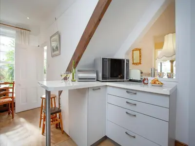 a kitchen with a counter top with a microwave at Chapel House in Polruan