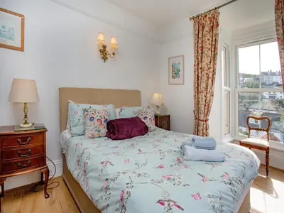 a bedroom with a bed and a window at Chapel House in Polruan