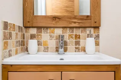 a bathroom sink with two vases on top of it at Cornwall cottage The Old Piggery in Liskeard