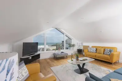 a living room with a couch and a tv at Sea views - 500 metres from the sea - Parking in St Ives