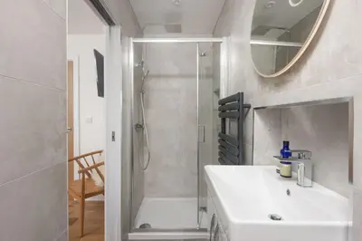 a bathroom with a white sink and a shower at Sea views - 500 metres from the sea - Parking in St Ives