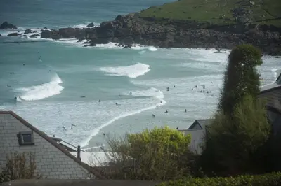 a group of people in the water at the beach at Sea views - 500 metres from the sea - Parking in St Ives