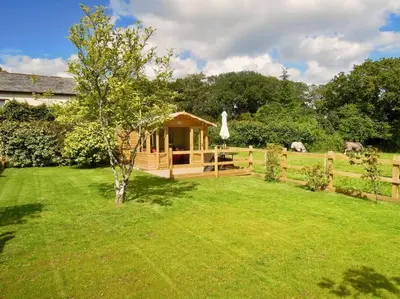 a gazebo in the yard of a house at The Piggery in St Austell