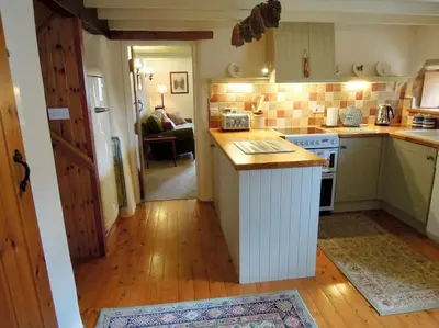 a kitchen with a island in the middle of a room at The Oxen House in St Austell