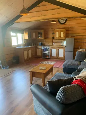 a living room with a couch and a table at Brook lodge 2 in Liskeard