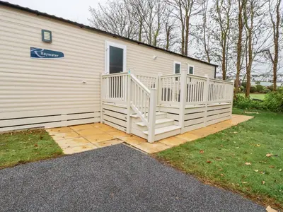 a house with a white ramp next to a building at The Mermaid A04 in Par