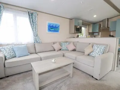 a living room with a couch and a table at The Mermaid A04 in Par