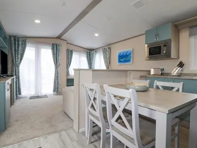 a kitchen and dining room with a table and chairs at The Mermaid A04 in Par