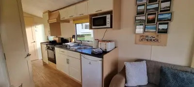 a small kitchen with a sink and a microwave at Coastal Retreat Newquay NB91 in Newquay