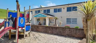 a house with a playground in front of it at Coastal Retreat Newquay NB91 in Newquay