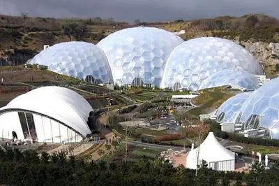 a group of domed buildings in a field at Two Bedroomed Holiday Cottage with Sea Views in St Austell