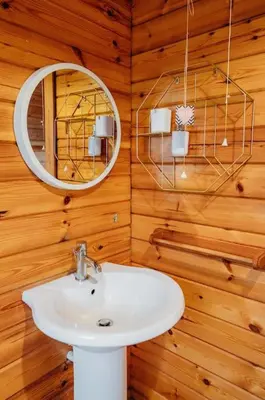 a bathroom with a sink and a mirror at Finlodge- Pet-Friendly Scandinavian Cabin in Callington