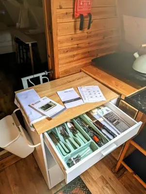 a small cabinet with a drawer full of tools at Robin Nest - Cosy Shepherd's Hut Hideaway in Callington