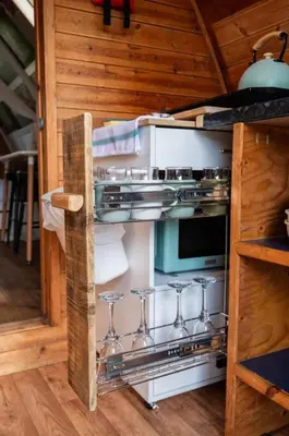 a kitchen with an oven with wine glasses in it at Robin Nest - Cosy Shepherd's Hut Hideaway in Callington