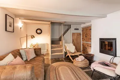 a living room with a couch and a tv at The Shambles in Port Isaac