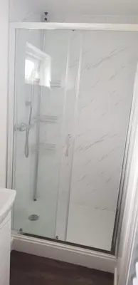 a shower with a glass door in a bathroom at Self contained annex in Bodmin