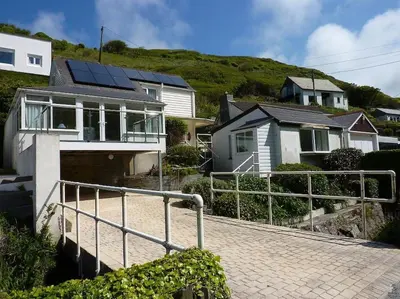 a house with solar panels on top of it at Tides Reach - Trebarwith Strand - North Cornwall - Sleeps 4 - 6 in Treknow